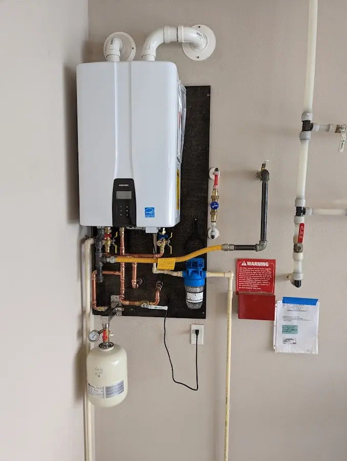 Professional plumber installing copper piping in a Canterbury home